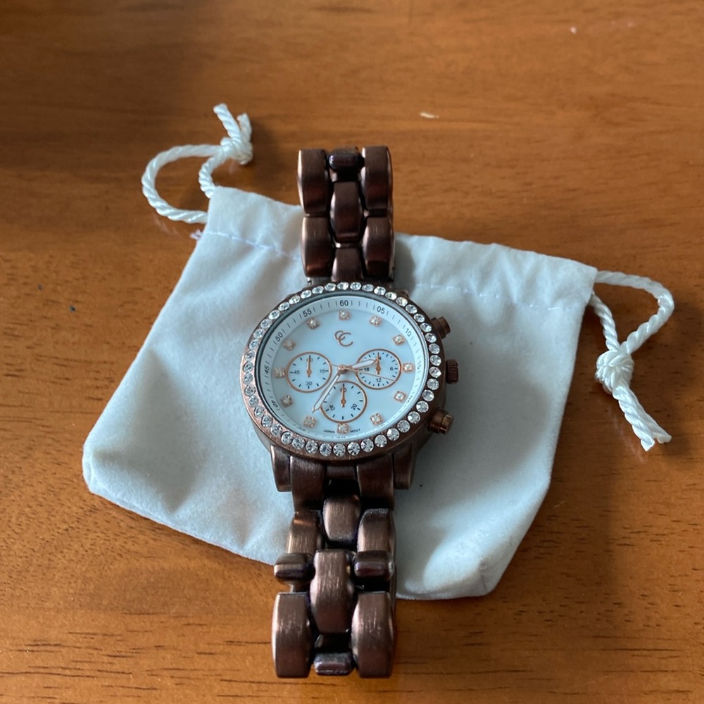 Wrist watch, bronze adjustable bracelet. 1 inch face.